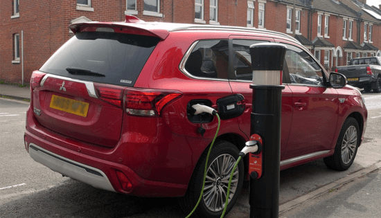 EV Charging on street red car